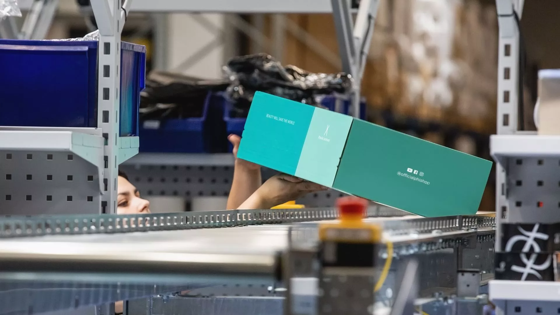 Package being picked up from a conveyor belt