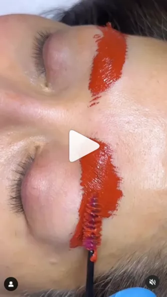 Pigment masking technique video thumbnail, showing woman with red pigment mask