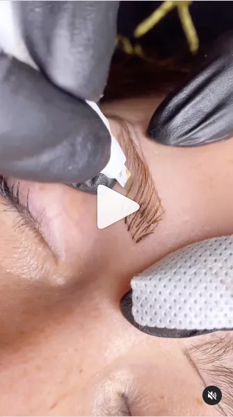 Artista esegue il microblading di sopracciglia con la Grand Master Blade U24 e guanti sterili.